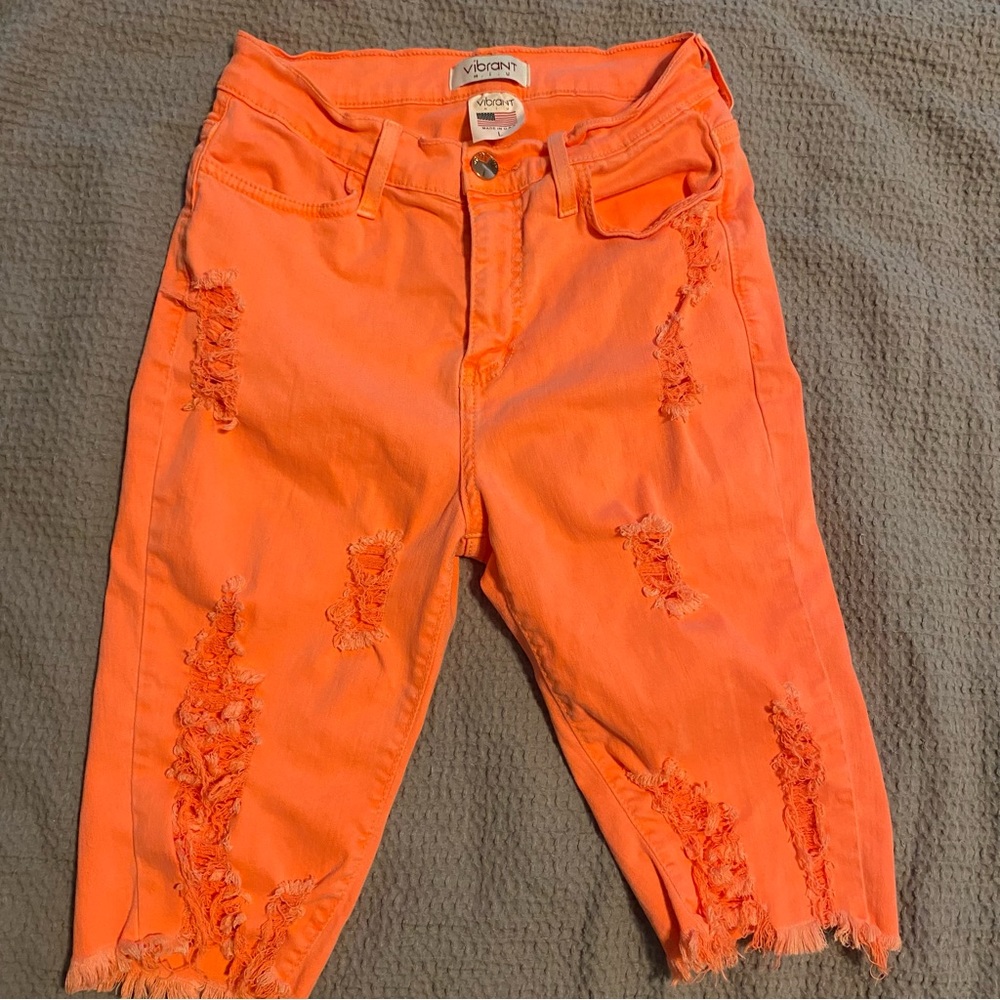 Vibrant shorts- bright orange-above the knee- size large they run more like Med.